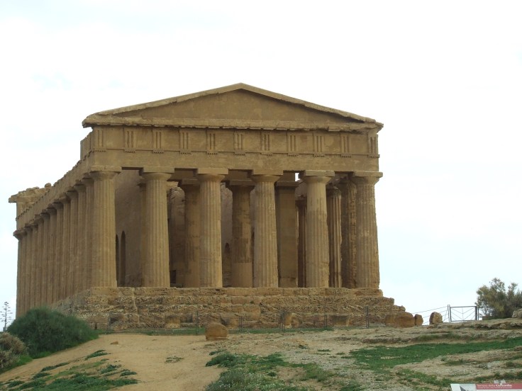 The Temple of Concordia, an ancient Greek temple in Agrigento, Sicily, showcasing classic architecture with tall columns and a stone facade.
